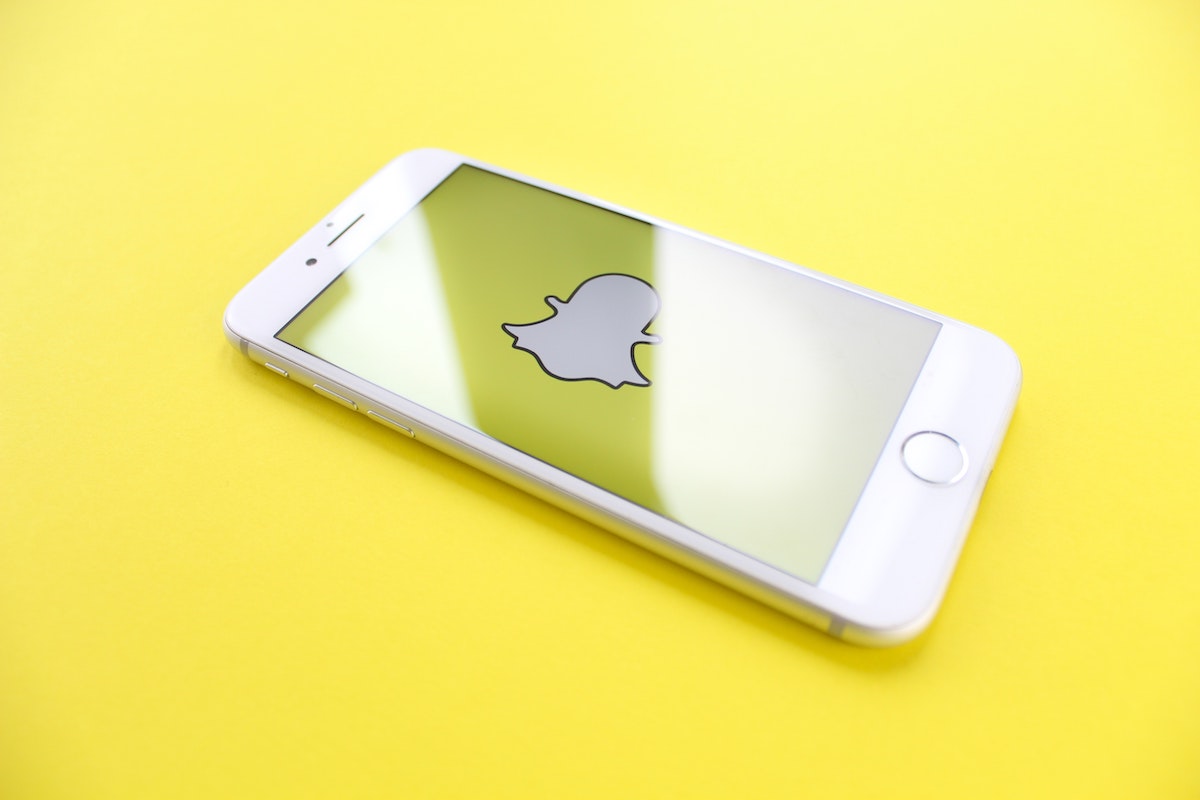 white iphone with snapchat app open, yellow background; blog; snapchat advertising