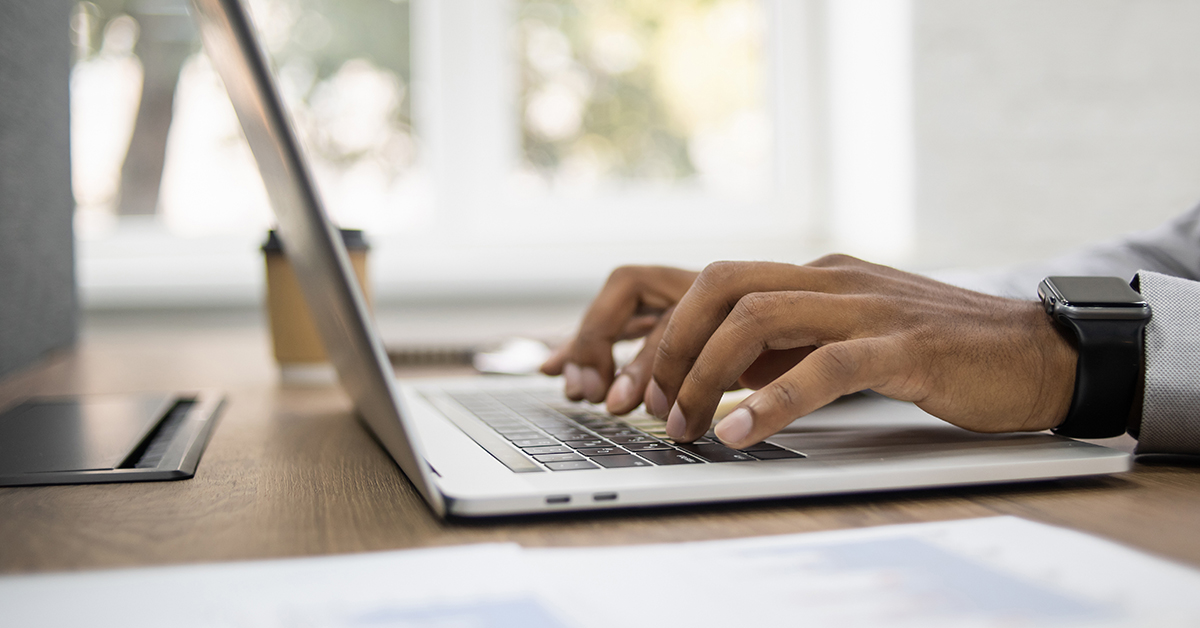 Man hands typing on computer keyboard closeup, blog: increase customer engagement