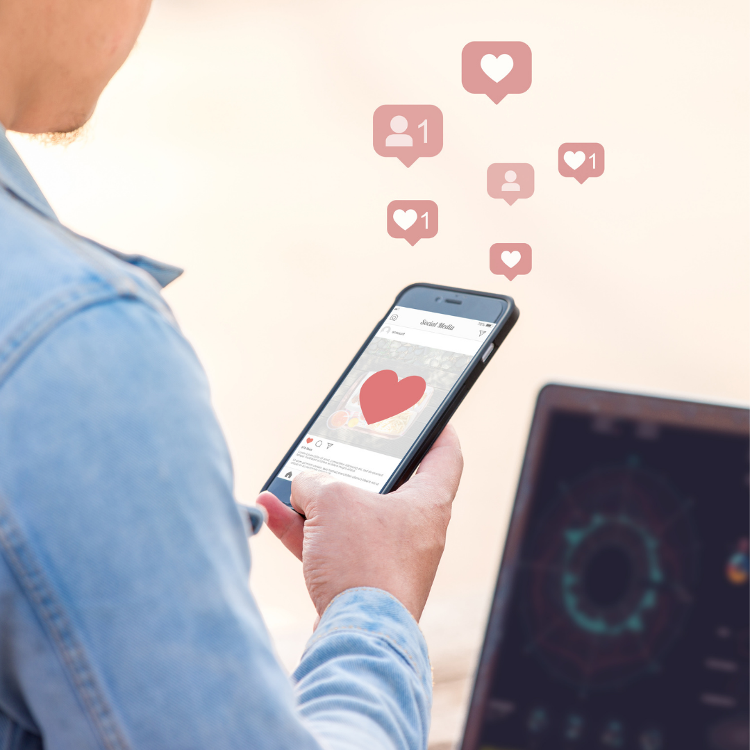 woman holding smartphone with heart and follow icons; blog: expand your reach on instagram