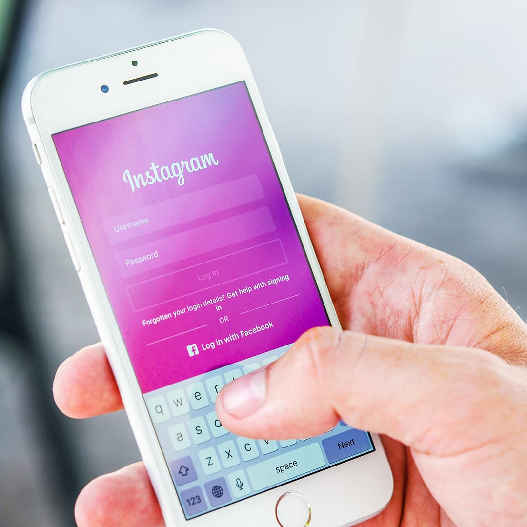 Person Holding Phone While Logging-in on Instagram Application; blog: why you should keep your personal and professional social media separate